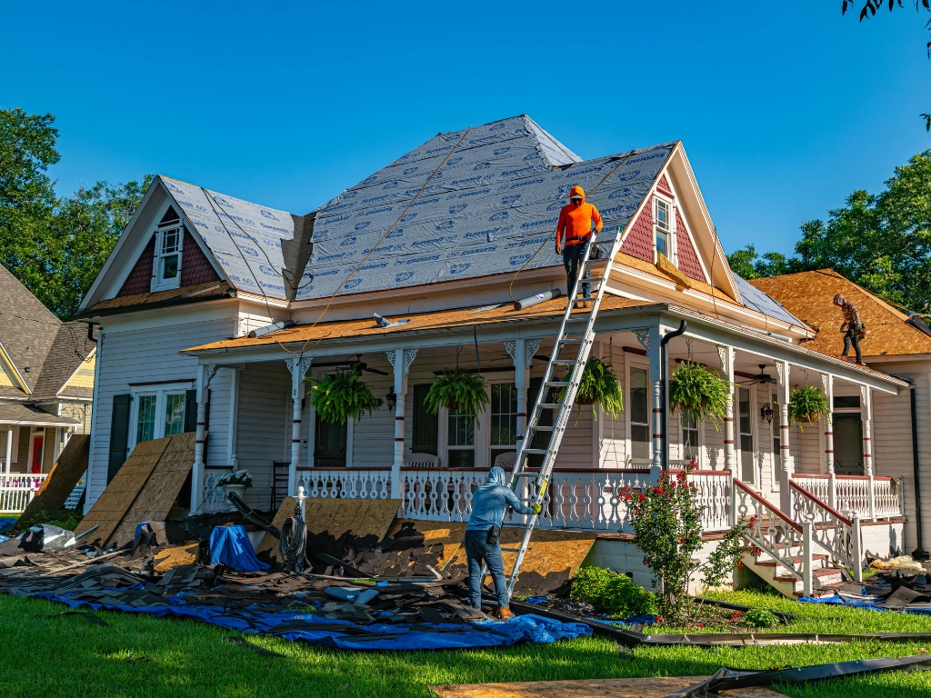Roofing contractors replacing and installing a new roof on a residential home